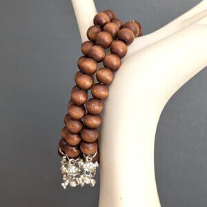 3 stretch wooden bead bracelets with silver skull and cz charm accents